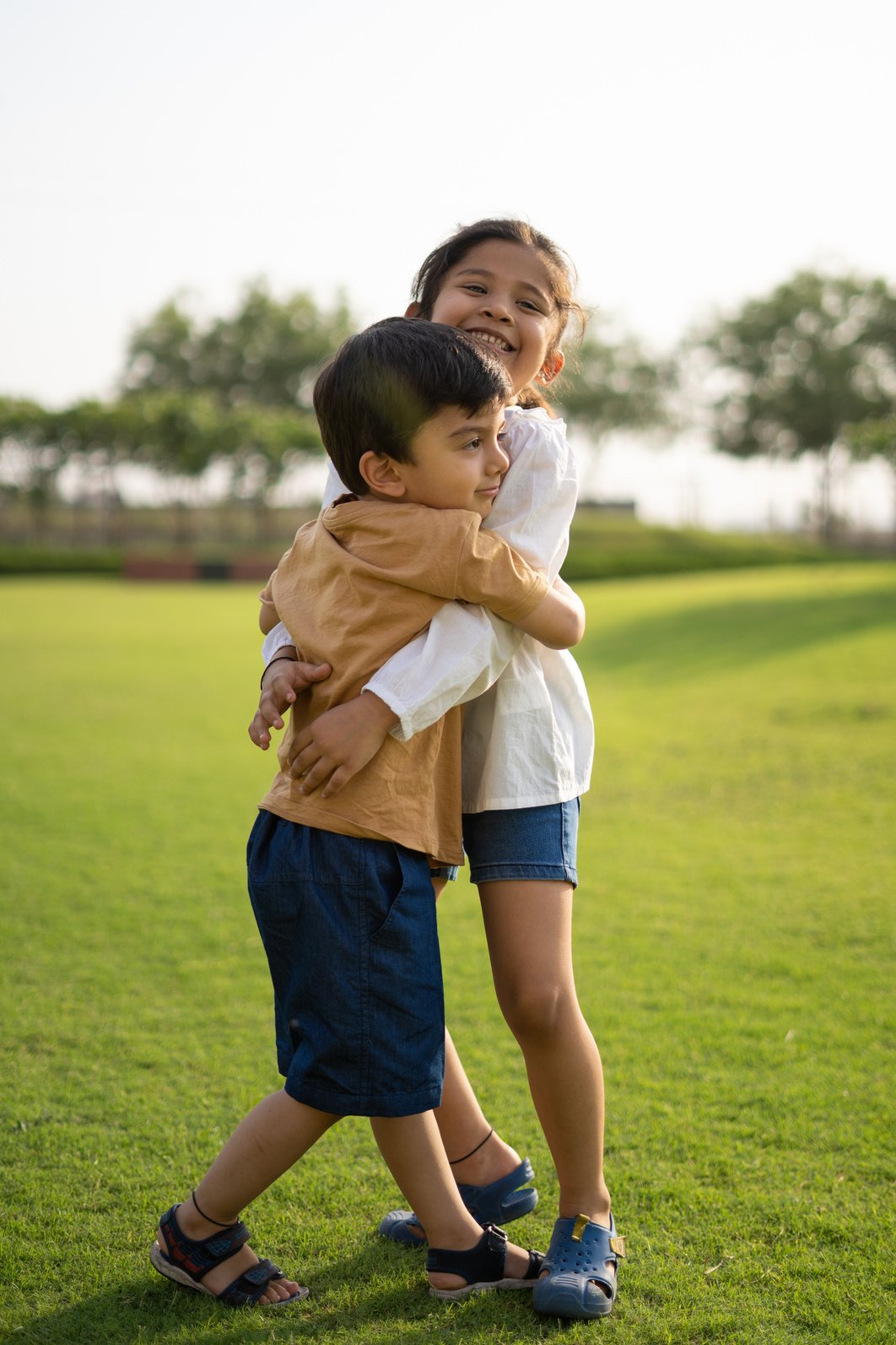 Happy Children Hugging Each Other Outdoors